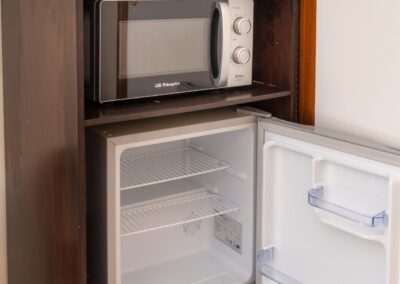 Refrigerator and microwave in «la Puput» room